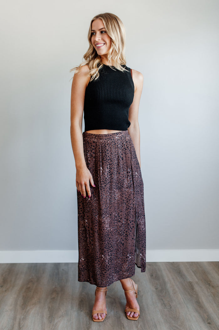 Pictured is a velvet-purple, print midi skirt with an animal print pattern, high-waisted fit, and side slit.