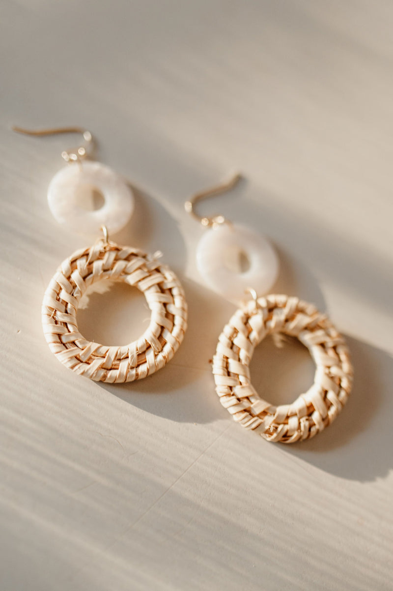 Pictured are boho, double hoop earrings with alternating hoop material and light color palette.