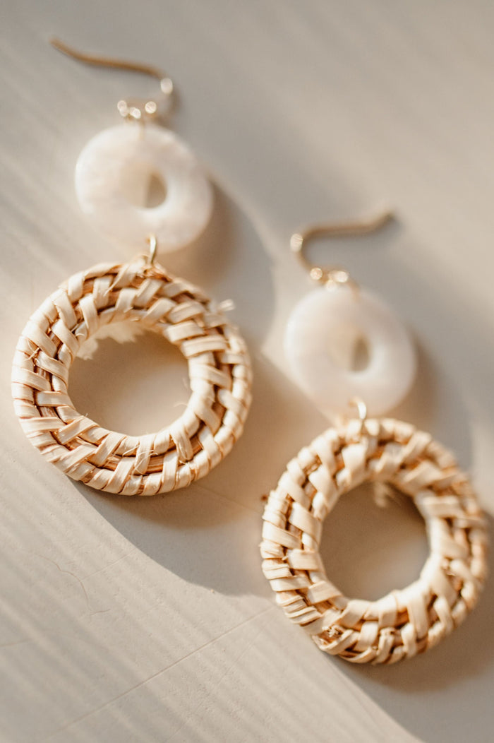 Pictured are boho, double hoop earrings with alternating hoop material and light color palette.
