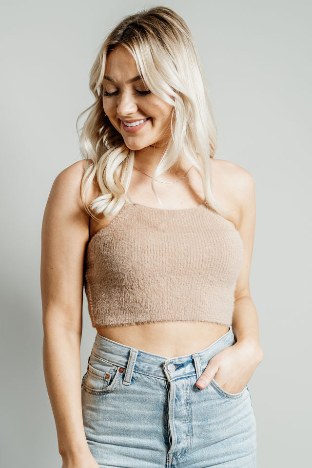 Pictured is a brown, knit top with fuzzy material, thin shoulder straps, and cropped body. 