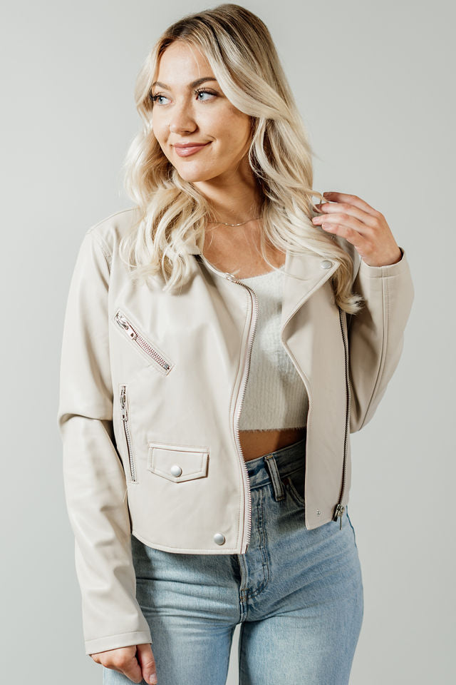 Pictured is a light nude jacket with a collar, zipper closure, various pockets, and faux leather material.
