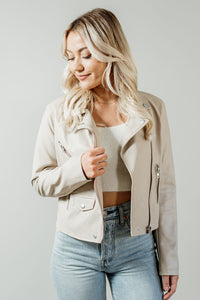 Pictured is a light nude jacket with a collar, zipper closure, various pockets, and faux leather material.