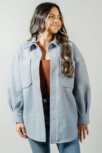 Pictured is a sturdy jacket with snap button closures, cuff sleeves, front pockets, and a gray-blue hue.