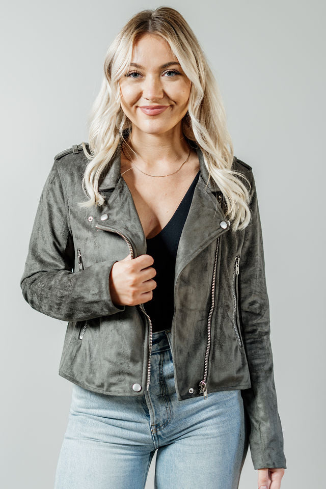 Pictured is a grunge-green, suede jacket with a moto-style collar, zipper closure, and side pockets with zippers.