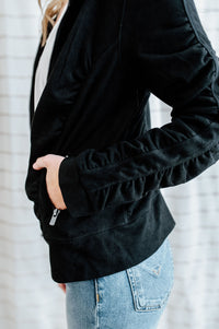Velvet black, zip up jacket with side and sleeve ruching on model.