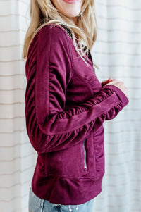Velvet purple-red, zip up jacket with side and sleeve ruching on model.