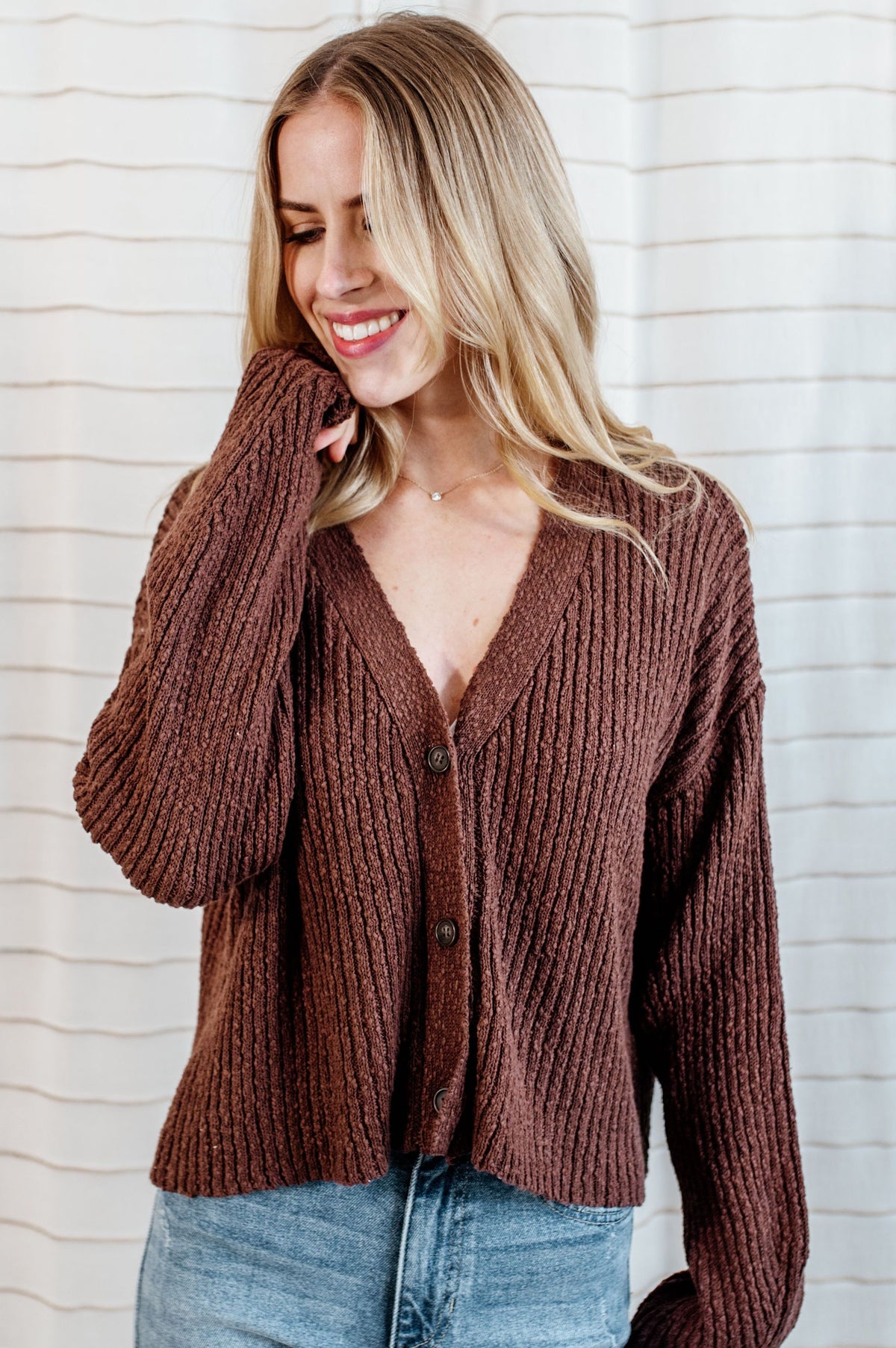 Pecan, knit cardigan sweater with v-neck button down front on model.