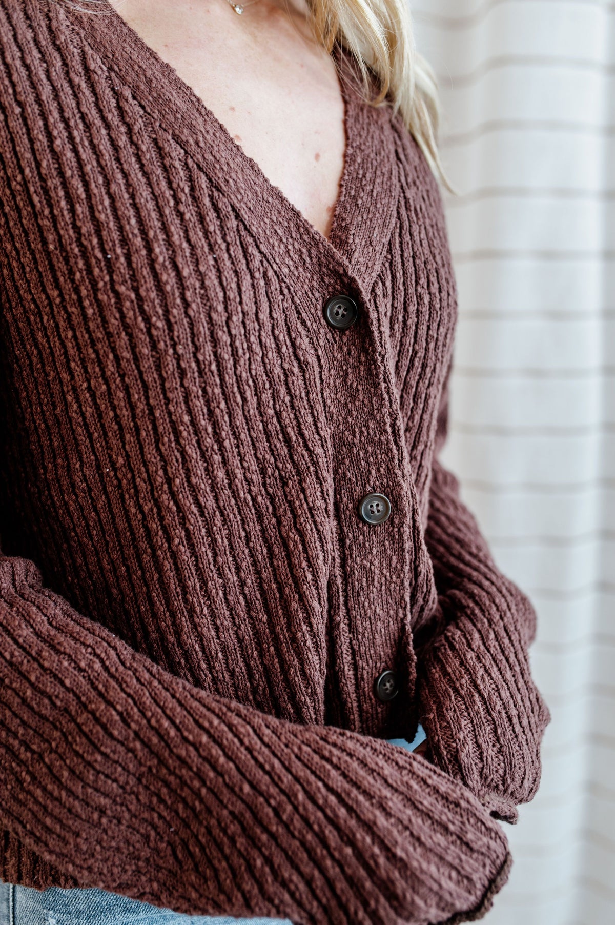 Pecan, knit cardigan sweater with v-neck button down front on model.