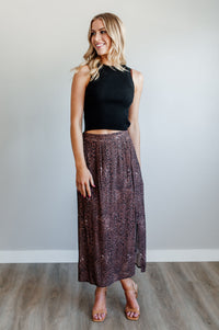 Pictured is a velvet-purple, print midi skirt with an animal print pattern, high-waisted fit, and side slit. 