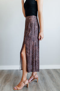 Pictured is a velvet-purple, print midi skirt with an animal print pattern, high-waisted fit, and side slit. 