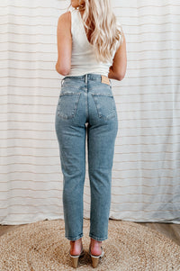 Light wash, mid-rise denim with knee distressing on model.