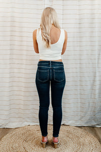 Pictured are med-wash, denim skinny jean with a low-rise waist, dark-wash, and skinny fit.